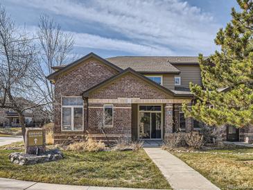 Charming two-story home featuring brick and neutral siding, complemented by a well-maintained lawn and inviting entrance at 6444 Silver Mesa Dr # A, Highlands Ranch, CO 80130