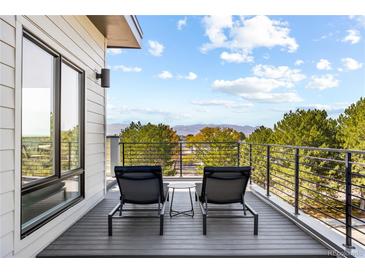 Relax on the private balcony with mountain views, perfect for outdoor seating and enjoyment at 9052 Harlan St, Westminster, CO 80031