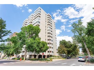 Bright exterior shot of a tall building with multiple stories, balconies and beautiful trees nearby at 1200 N Humboldt St # 1204, Denver, CO 80218