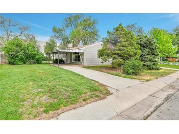 Charming single-story home with a well-maintained lawn, covered front porch, and convenient driveway at 4155 S Lipan St, Englewood, CO 80110