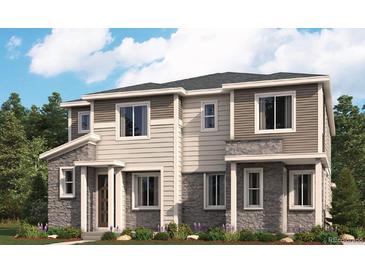 Beautiful two-story townhome featuring stone accents, neutral siding, and a well-manicured lawn at 24088 E Warm Springs Ave, Aurora, CO 80019