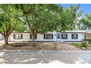 Charming single-story home with a well-maintained lawn and mature trees at 5325 Allison St, Arvada, CO 80002