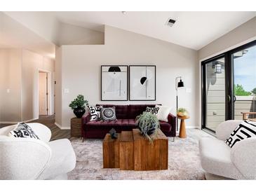 Bright living room featuring modern decor, stylish furniture, and access to a patio at 7408 S Alkire St # 301, Littleton, CO 80127