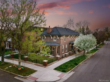 Beautiful brick home with a charming front yard, mature trees, and a picturesque view at 201 S Lafayette St, Denver, CO 80209