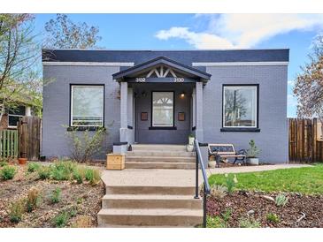Charming gray brick home with a cozy covered entry and inviting front yard landscaping at 3130 N Race St, Denver, CO 80205