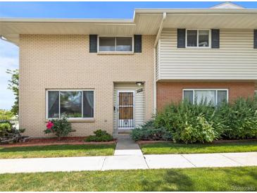 Charming two-story townhouse featuring a well-manicured lawn and attractive brick and siding facade at 3981 S Boston St, Denver, CO 80237