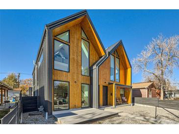 Striking modern home with unique architectural design, wood and metal accents, and large windows at 3829 Osage St, Denver, CO 80211