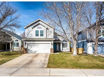 Charming two-story home with a well-maintained front yard and a two-car garage on a sunny day at 11335 Haswell Dr, Parker, CO 80134