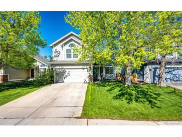 Charming home featuring a two car garage, lush lawn, mature trees, and delightful curb appeal at 11335 Haswell Dr, Parker, CO 80134