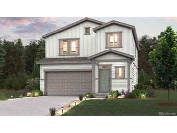 Two-story house with gray siding, attached garage, and landscaping at 2215 Barnwood Dr, Brighton, CO 80601