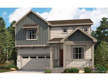 Charming two-story home featuring a covered porch, two-car garage, and landscaped yard at 45927 Wood Thrush Ave, Bennett, CO 80102