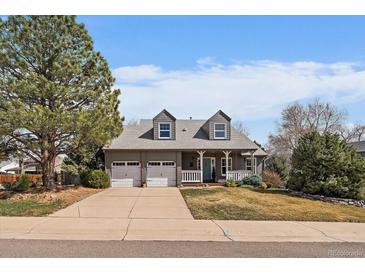 Charming two-story home with a well-manicured lawn and a two car garage at 7356 S Miller Ct, Littleton, CO 80127