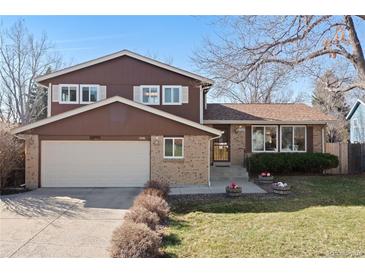 Charming two-story home features a two-car garage and a well-maintained front yard at 13648 W 66Th Way, Arvada, CO 80004