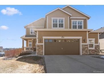 Charming two-story home with a two-car garage and a well-maintained lawn on a sunny day at 3762 White Rose Loop, Castle Rock, CO 80108