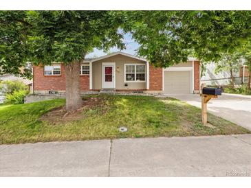 Charming single-Gathering home featuring a brick exterior, a well-manicured lawn, and mature trees for added curb appeal at 9054 Dover St, Westminster, CO 80021