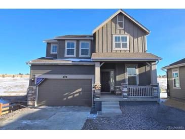 Two-story home with gray siding, stone accents, and a two-car garage at 250 Paloma Way, Elizabeth, CO 80107