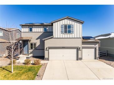 Charming two-story home with a three-car garage, well-maintained lawn, and solar panels at 2355 Saddle Back Ct, Fort Lupton, CO 80621