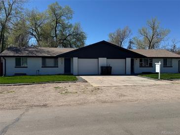Charming duplex features individual garages and yard space at 5780 W 5Th Ave, Lakewood, CO 80226