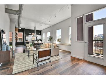 Bright and airy living room with hardwood floors and a view of the city at 2501 15Th St # 3F, Denver, CO 80211