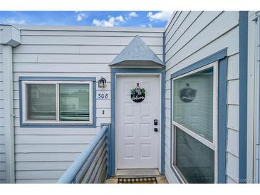 Charming condo entrance with a welcoming door, unit number, and fresh blue and white exterior at 1226 S Monaco Pkwy # 308, Denver, CO 80224