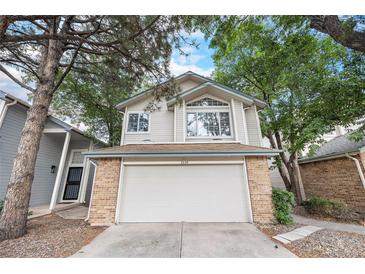 Charming two-story home with brick-accented garage, surrounded by mature trees at 2238 S Nile Ct, Aurora, CO 80014