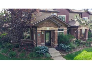 Charming townhome with brick facade and well-maintained landscaping at 6430 Silver Mesa Dr # D, Highlands Ranch, CO 80130