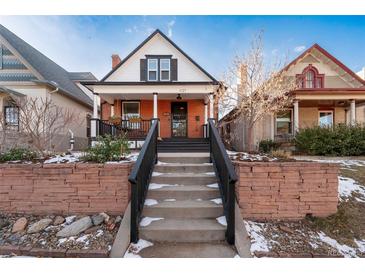 Charming brick home with a front porch and landscaped yard at 1127 Clayton St, Denver, CO 80206