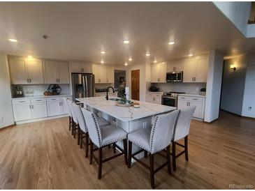 Well-appointed kitchen features a large center island, modern appliances, and plenty of counter space for meal preparation at 9983 Cottoncreek Dr, Highlands Ranch, CO 80130