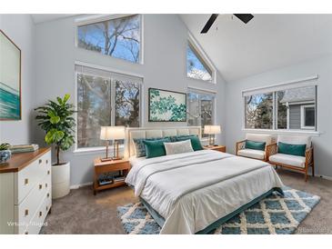 Bright bedroom with vaulted ceiling, multiple windows, and tasteful decor create an airy and inviting atmosphere at 12525 E Tennessee Cir # E, Aurora, CO 80012