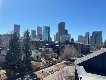 Stunning city view with downtown skyscrapers rising above charming neighborhood homes under a clear blue sky at 2589 Arapahoe St, Denver, CO 80205