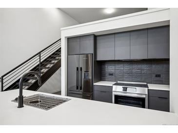 Stylish kitchen features stainless steel appliances and white countertop at 1601 Park Ave # 110, Denver, CO 80218