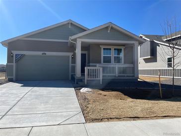 Charming one-story home with a covered porch, attached garage, neutral color palette and easy to maintain landscape at 16602 E 109Th Ave, Commerce City, CO 80022