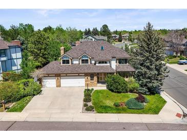 Charming two-story home featuring a three-car garage and beautifully landscaped front yard at 5694 S Pagosa Ct, Centennial, CO 80015