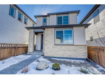 Charming two-story home with stone accents and well-maintained landscaping at 21242 E 63Rd Dr, Aurora, CO 80019