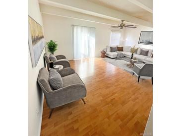 Bright living room with hardwood floors, and large windows providing ample natural light at 9995 E Harvard Ave # 177, Denver, CO 80231