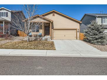 Charming single-Gathering home features a two-car garage, covered porch, and well-maintained front yard at 1820 Taos St, Brighton, CO 80603