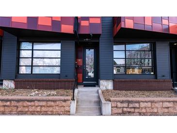 Modern exterior entrance featuring gray siding, brick accents, and large windows for ample natural light at 722 W 6Th Ave, Denver, CO 80204