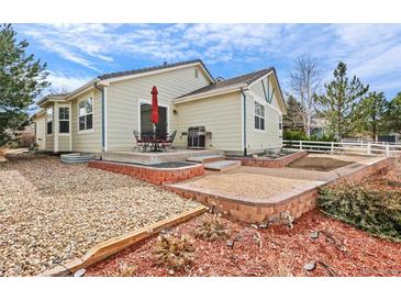 Inviting backyard featuring a patio, a built-in grill, and landscaped areas perfect for outdoor entertaining at 1128 S Duquesne Cir, Aurora, CO 80018