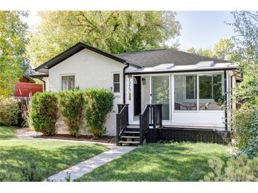 Charming updated bungalow with a sunroom and well-manicured lawn at 1315 Holly St, Denver, CO 80220