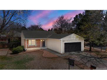 Charming single-story home featuring a two-car garage and beautiful brick accents at 15875 E Custer Dr, Aurora, CO 80017