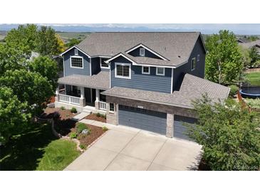 Stunning two-story home with a three-car garage, beautiful landscaping, and mountain views at 879 Quintana Ln, Erie, CO 80516