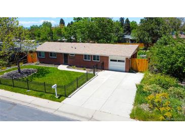 Charming brick home with a well-maintained lawn, mature trees, and a spacious driveway at 885 Balsam St, Lakewood, CO 80214