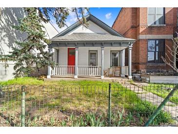 Charming home with a bright red door, quaint porch, and a well-maintained front yard at 2322 Arapahoe St, Denver, CO 80205