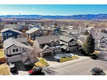 Inviting neighborhood boasts stunning mountain views and well-maintained homes under a bright, clear sky at 3224 White Oak St, Highlands Ranch, CO 80129