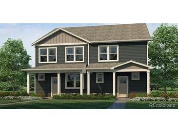 Charming gray two-story home with well-maintained lawn and inviting front porch at 1380 S Boston Ct # B, Denver, CO 80247