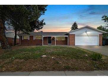 Charming brick home with a covered front porch and attached two-car garage at 396 S Troy St, Aurora, CO 80012