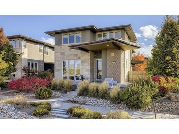 Modern two-story home features a unique architectural design with professional landscaping and inviting front porch at 9154 E 37Th Ave, Denver, CO 80238