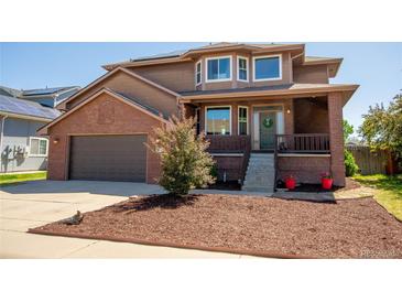 Two-story brick home with attached garage and landscaping at 5952 E Conservation Dr, Frederick, CO 80504