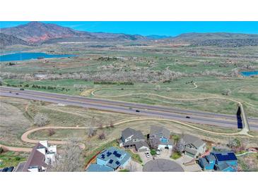 Expansive aerial view of a community with mountain views, highway access, and nearby lakes, with a great neighborhood at 4142 S Deframe Ct, Morrison, CO 80465