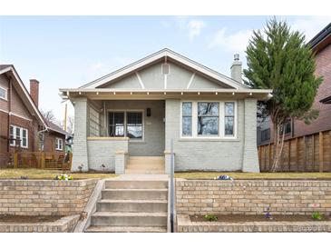 Charming home featuring a brick facade, manicured lawn, and inviting front porch at 764 S Corona St, Denver, CO 80209